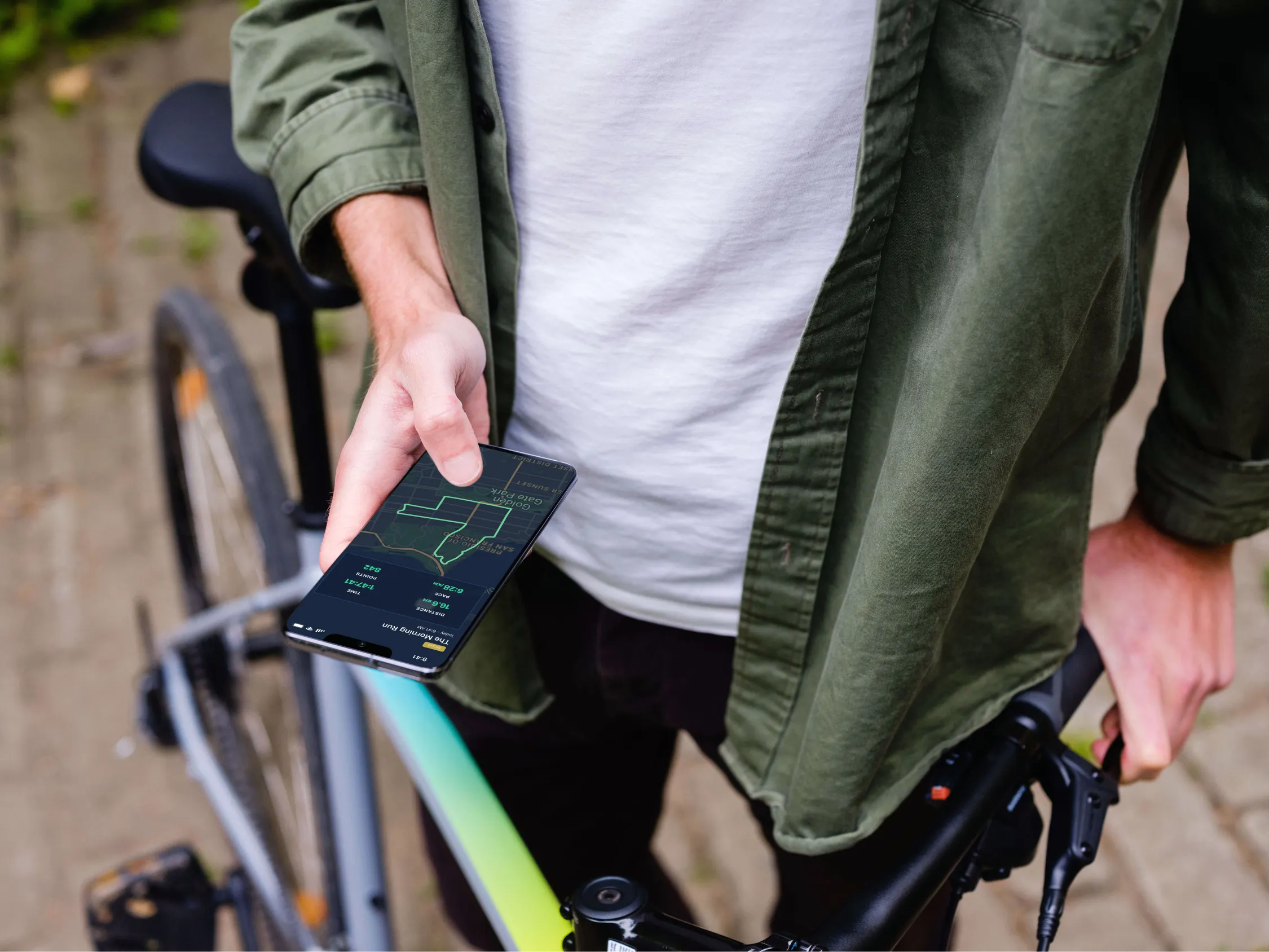 Free Holding Samsung S20 mockup in front of a bike (Mockuuups Studio)